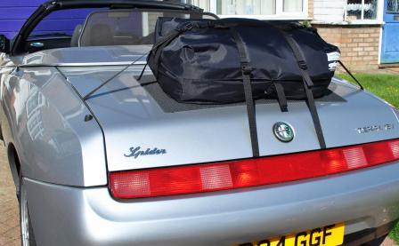 silver alfa romeo 916 spider with a boot-bag original boot rack fitted hood down on a sunny day
