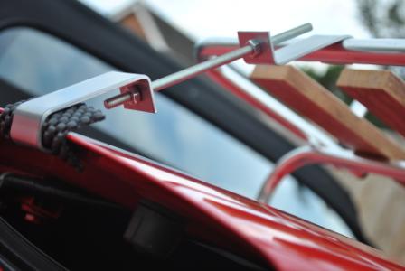 close up of the fixing brackets on a classic wood convertible car luggage rack