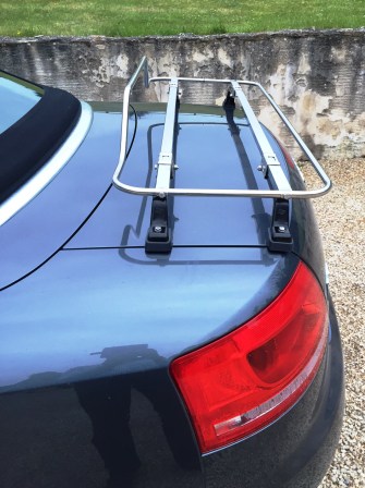 side view of a blue audi a4 convertible with a stainless steel boot rack fitted