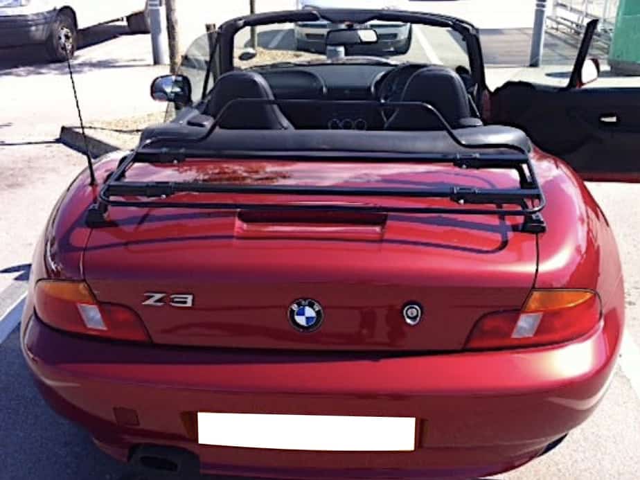 burgandy bmw z3 with the hood down and a black boot rack fitted