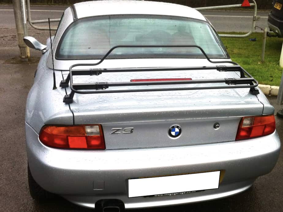silver bmw z3 with a hardtop fitted and a black boot rack in the rain