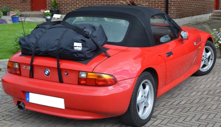 red bmw z3 with the hood up and a boot-bag vacation boot rack fitted
