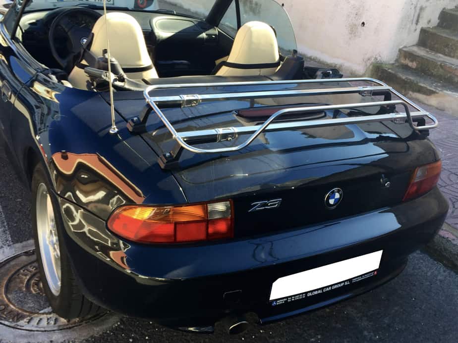 black bmw z3 with tan seats and the hood down on a sunny day with a stainless steel boot rack fitted