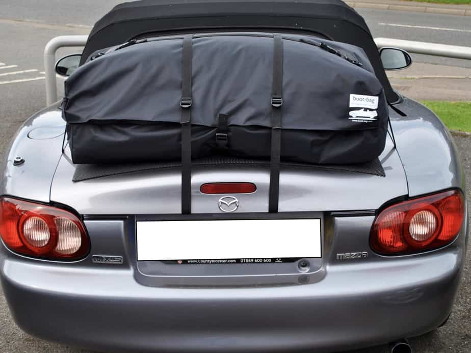 dark grey mazda mx5 mk2 with a boot-bag vacation boot rack fitted to the boot