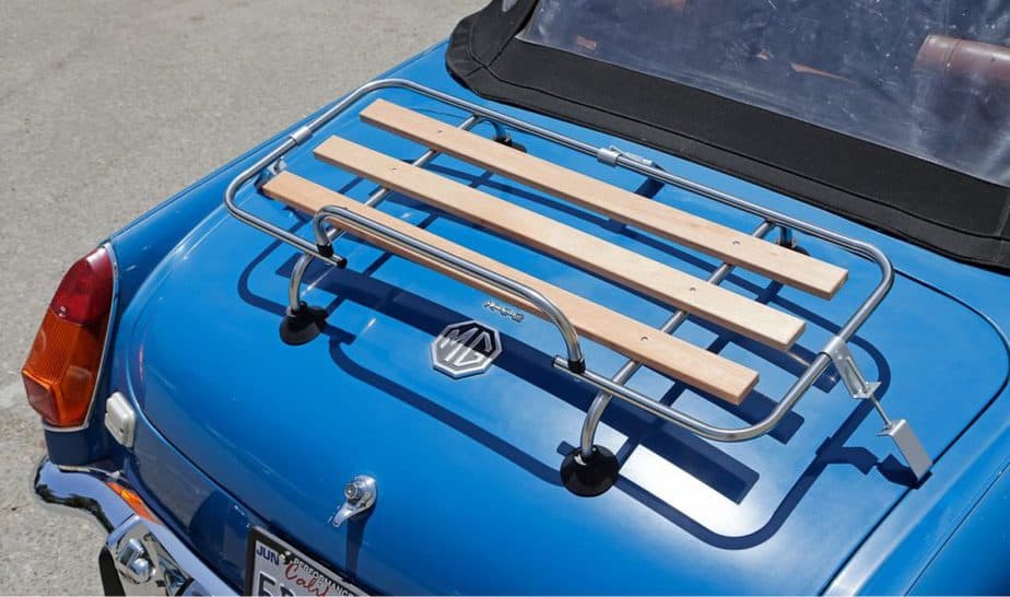 blue mgb on a sunny day with a chrome and wood boot rack attached to the boot lid