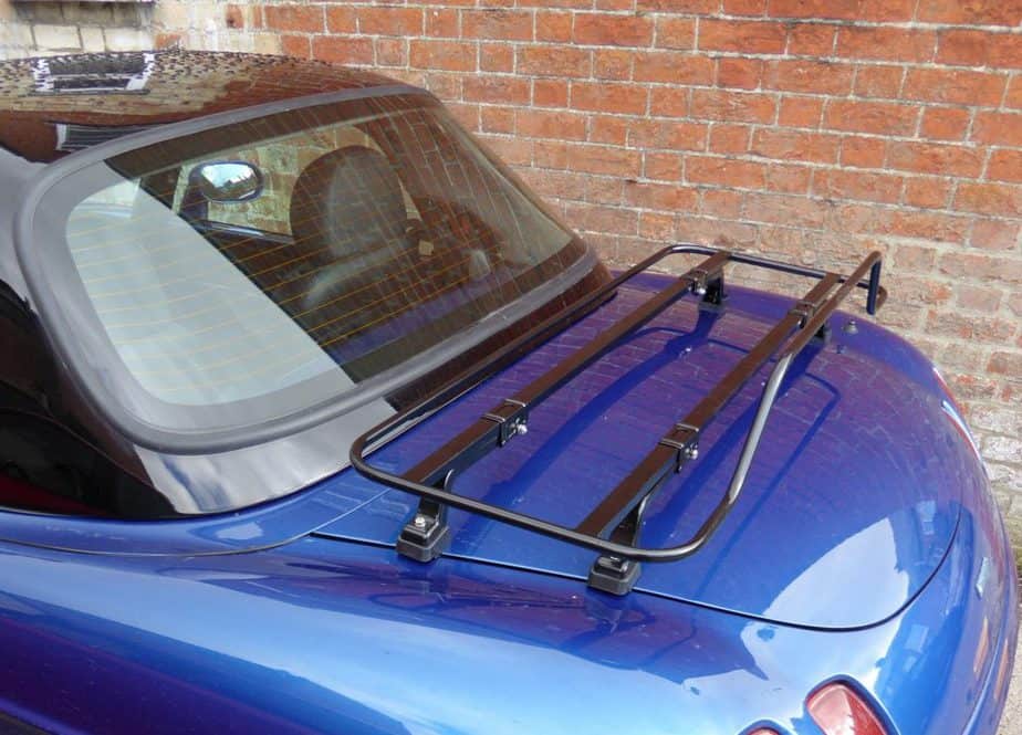 blue fiat barchetta with a black hardtop and a black luggage rack fitted to the boot lid