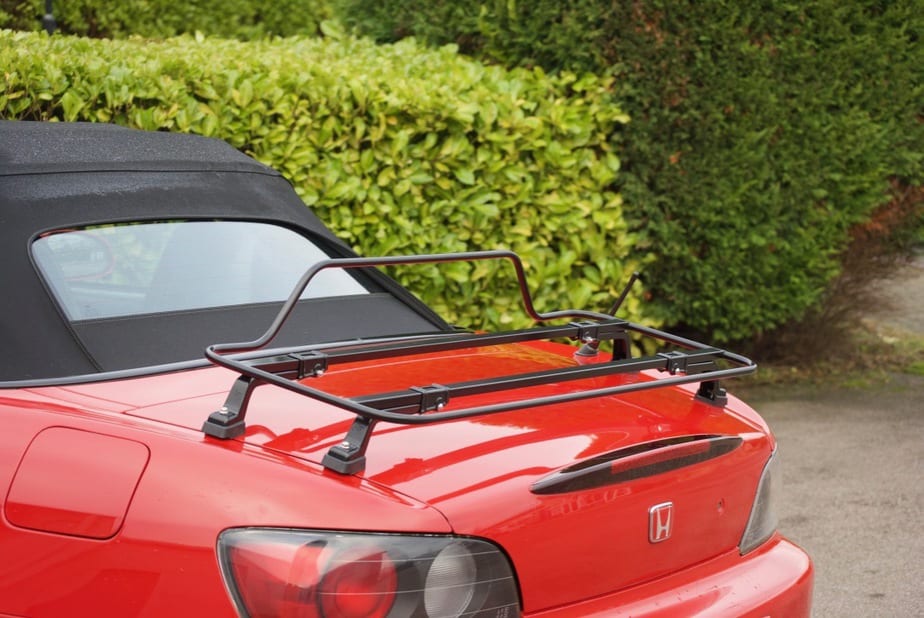 red honda s2000 with a black luggage rack fitted photographed from the side