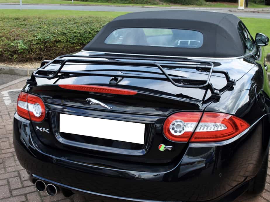 black jaguar xk cabriolet with a black luggage rack fitted