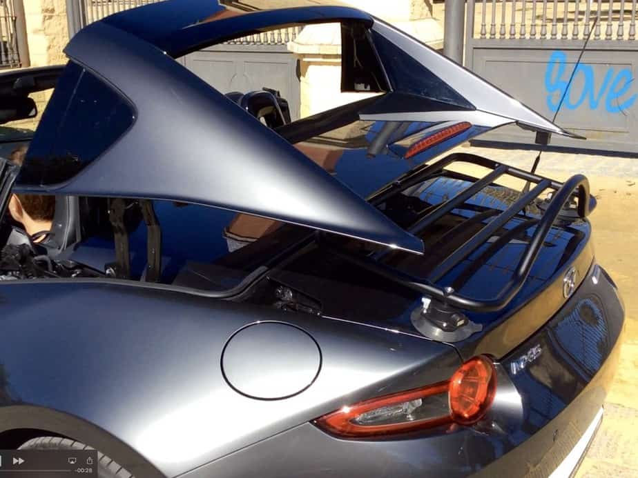Mazda mx5 rf in dark grey with a black revo-rack boot rack fitted showing the roof in operation with the rack fitted