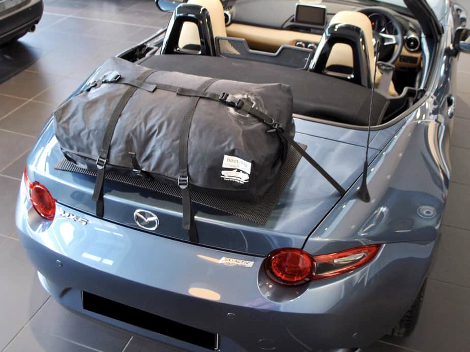 light blue mazda mx5 mk4 in a mazda showroom with a boot-bag boot rack fitted photographed from above