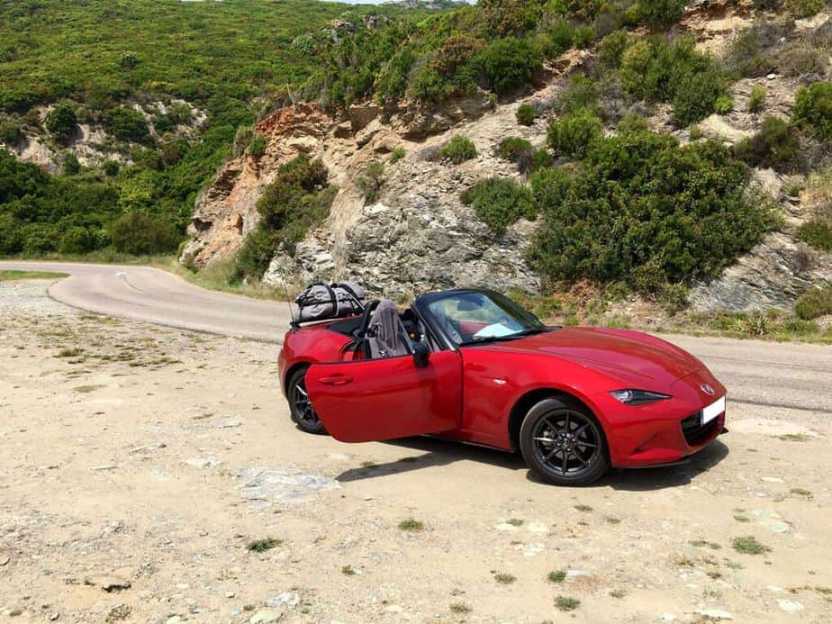 red mazda mx5 mk4 with a revo-rack boot rack fitted on a mountain road in corsica