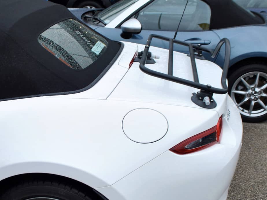 side view of a mazda mx5 mk4 in white with a revo-rack black boot rack fitted