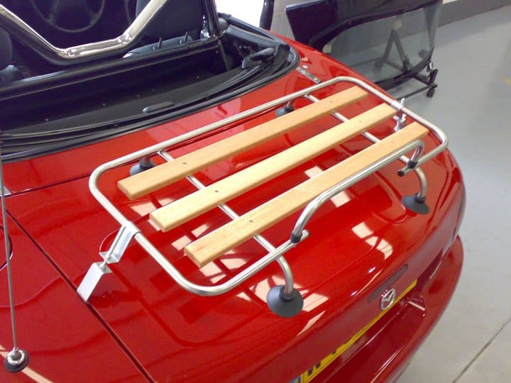 red mx5 mk2 with a classic wood boot rack fitted photographed at the rear from above