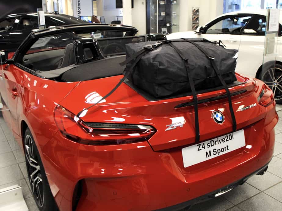 red bmw z4 g29 in a bmw showroom with a boot-bag original fitted