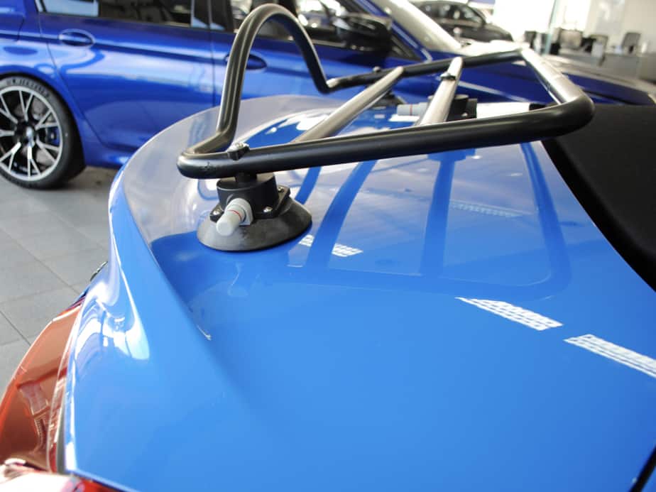 side view of a black boot rack fitted to a bmw z4 g29 in blue