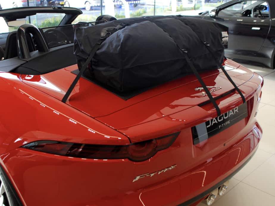 red jaguar f type convertible with the hood down in a Jaguar garage with a boot-bag boot rack fitted