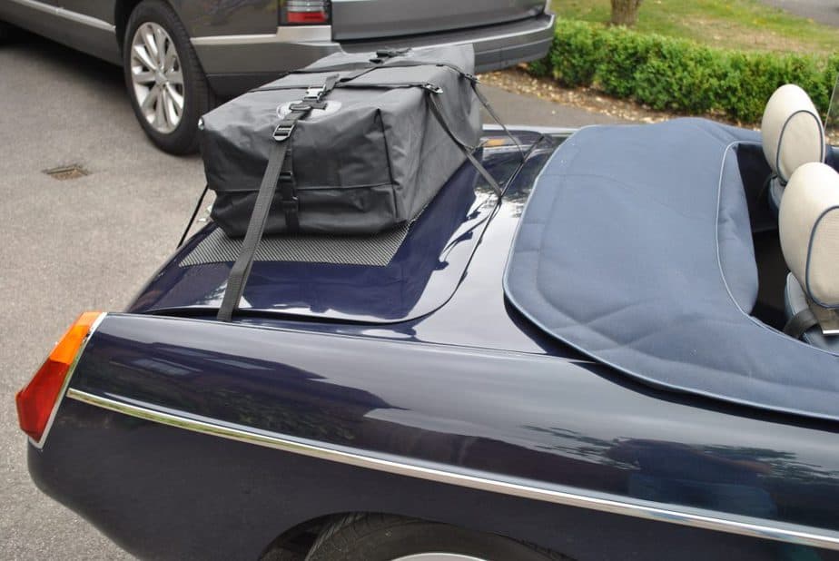 side view of a boot-bag original boot rack fitted to a blue MGB with the hood down