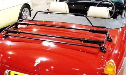 red mgb with the hood down and black boot rack fitted