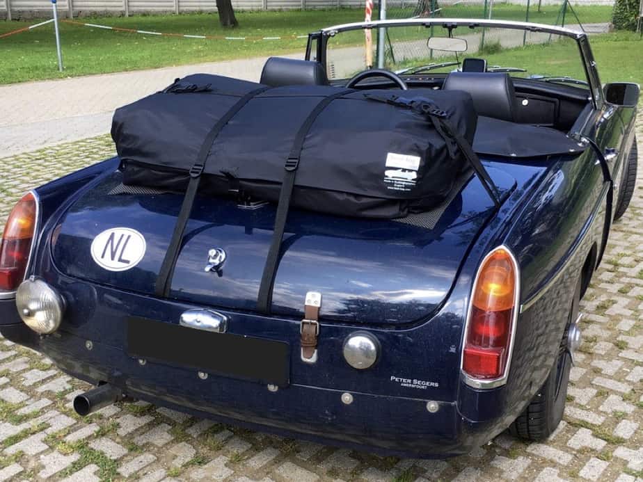 blue mgb with a boot-bag vacation boot rack fitted on a sunny day with the hood down