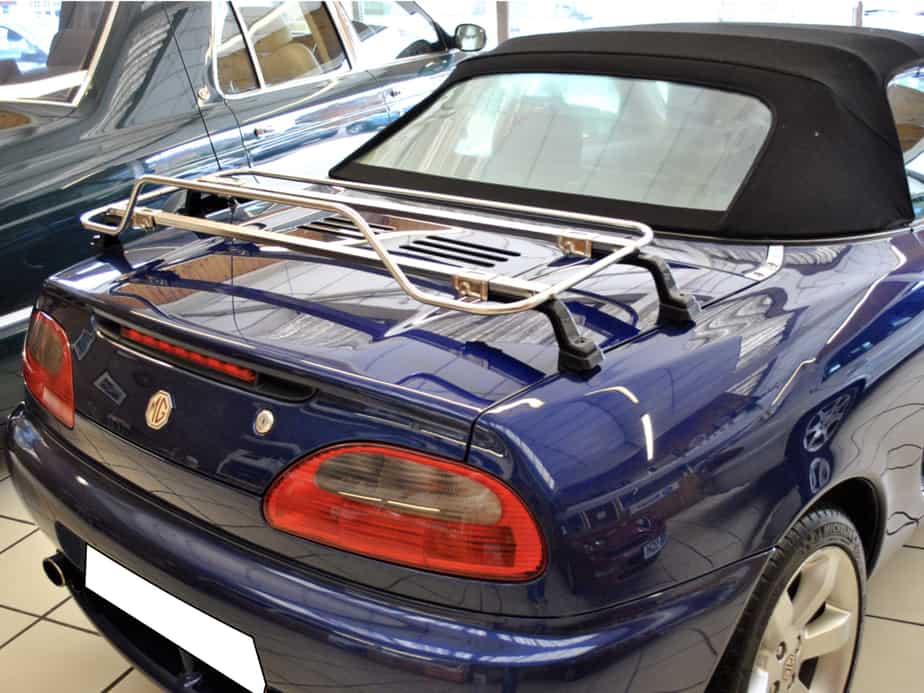 dark blue mgf in a car showroom with a stainless steel luggage rack fitted