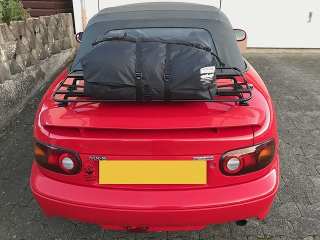 red mada mx5 mk1 with a black boot rack fitted