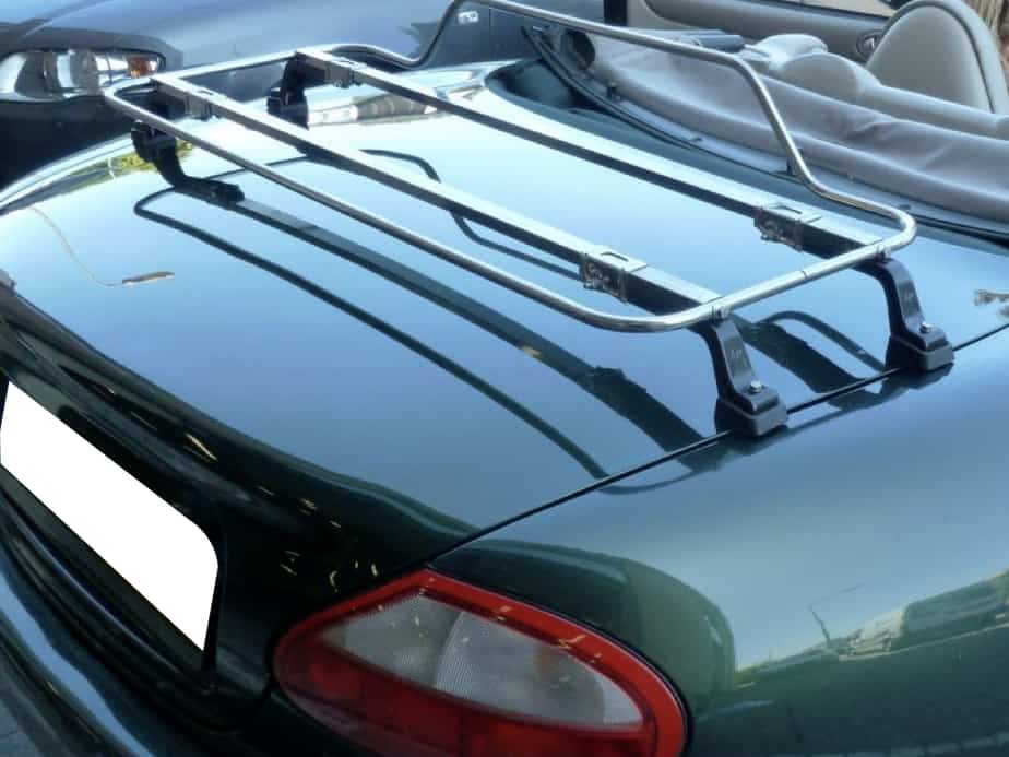 green jaguar xk8 convertible with the hood down and a stainless steel luggage rack fitted