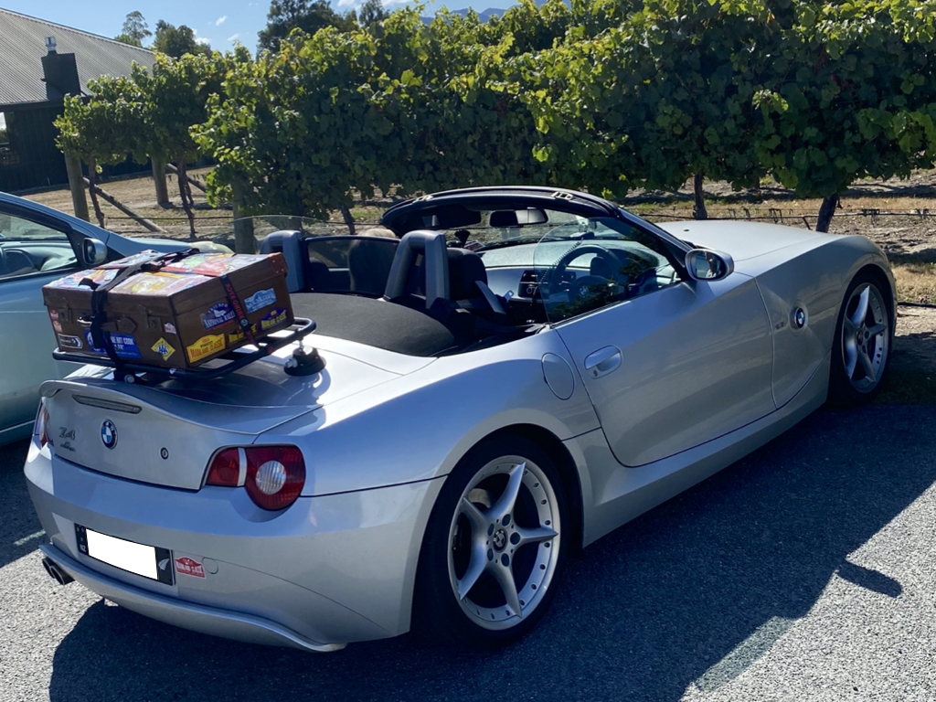 silver bmw z4 e85 with the roof down on a sunny day in a car park opposite a hedge with a revo-rack luggage rack fitted 