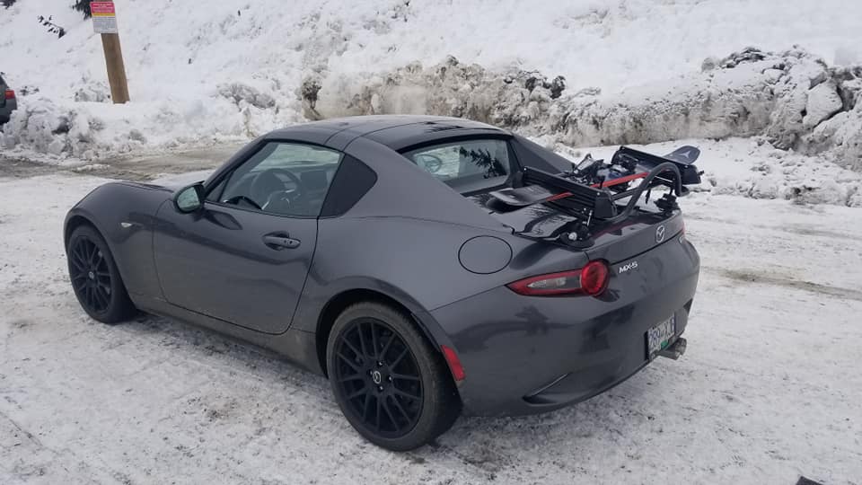 grey mazda mx5 miata rf in the show with a luggage rack fitted carrying ski's